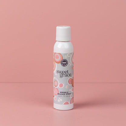 Sweet Grace Wrinkle Release Spray can with white cap, pink and beige label; freshens fabrics, eliminates odors. Available in multiple sizes.