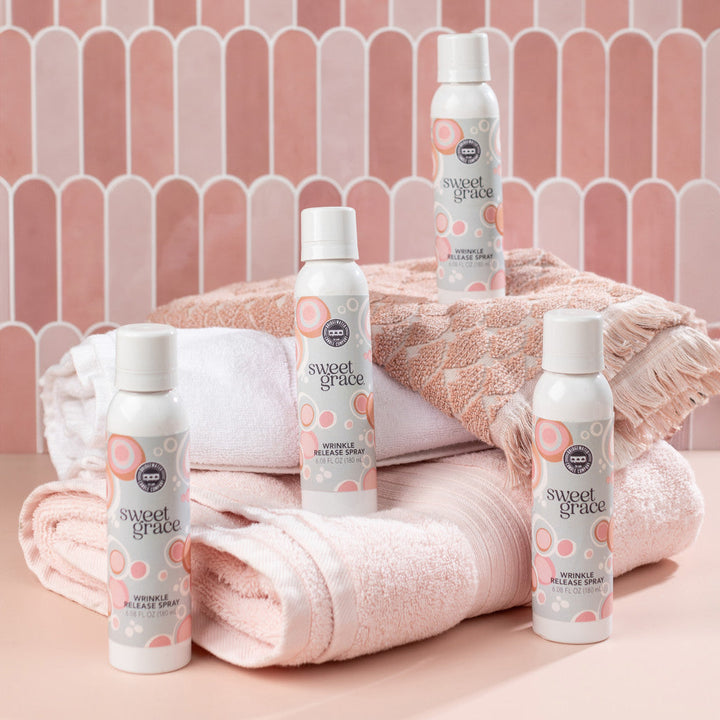 Four bottles of Sweet Grace Wrinkle Release Spray. Available sizes: 8oz and 32oz.