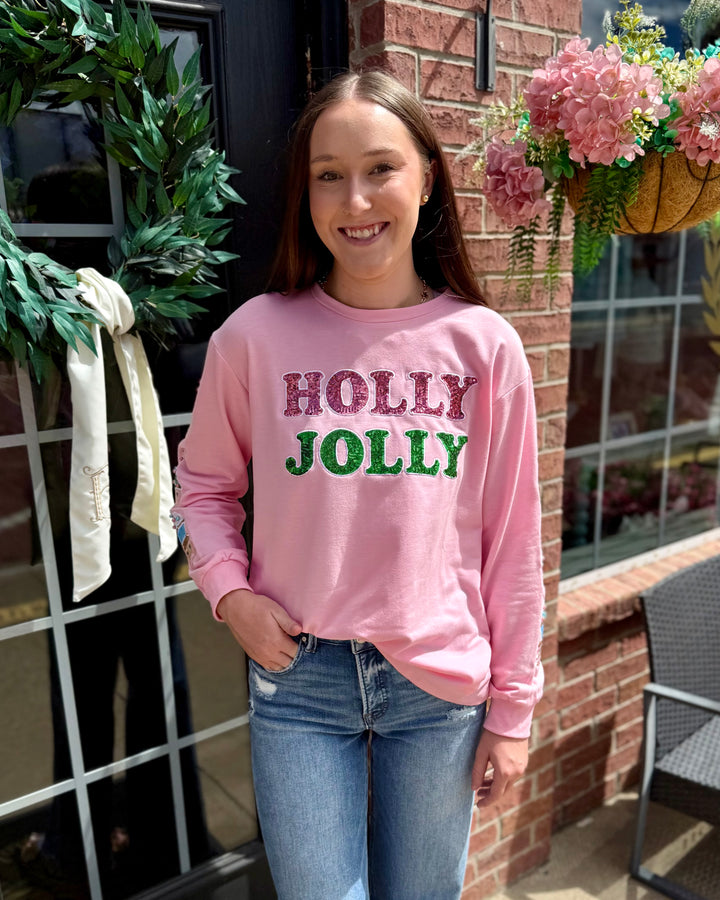 Pink Holly Jolly Sweatshirt, available in sizes S-XL.