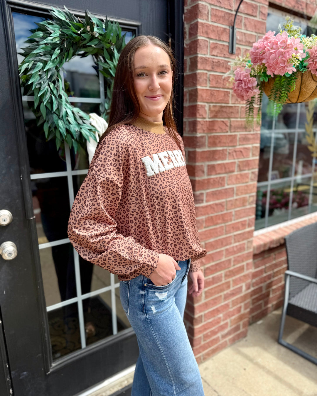 Leopard “Merry” Mock Neck sweater. Available in sizes XS–XL.