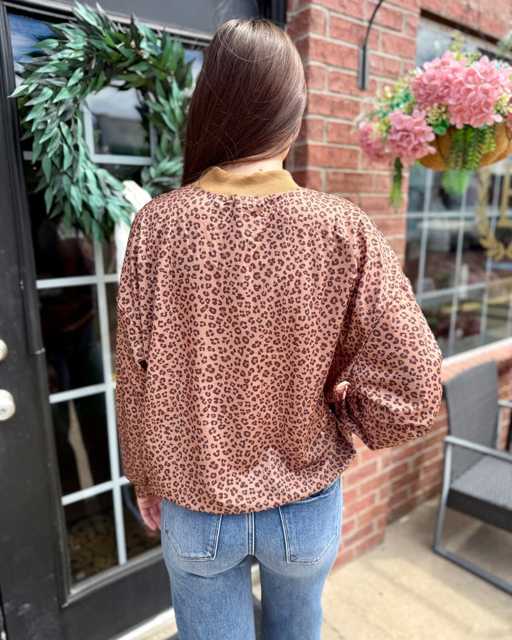 Leopard “Merry” Mock Neck; available in sizes S-XL.