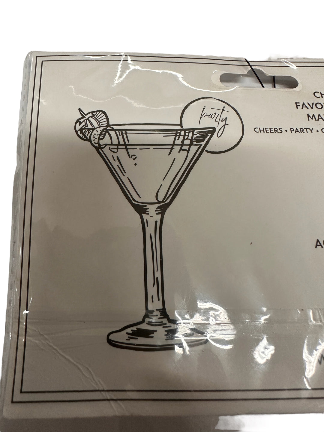 Black and white martini glass with garnish on a crumpled card reading "cheers" and "party." Available in multiple sizes.