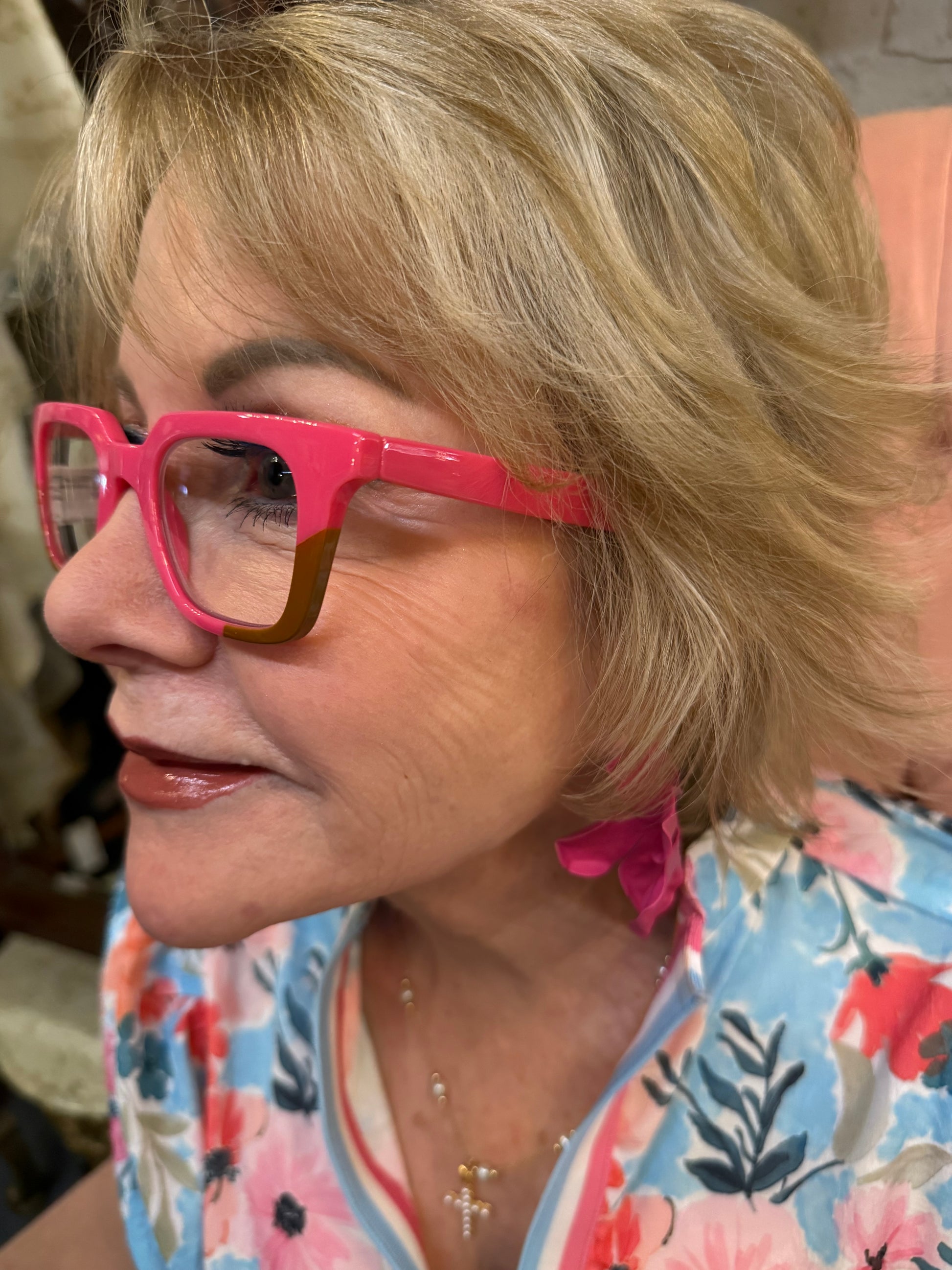 Bright pink Peepers Page blue light glasses shown. Sizes: Small, Medium, Large.