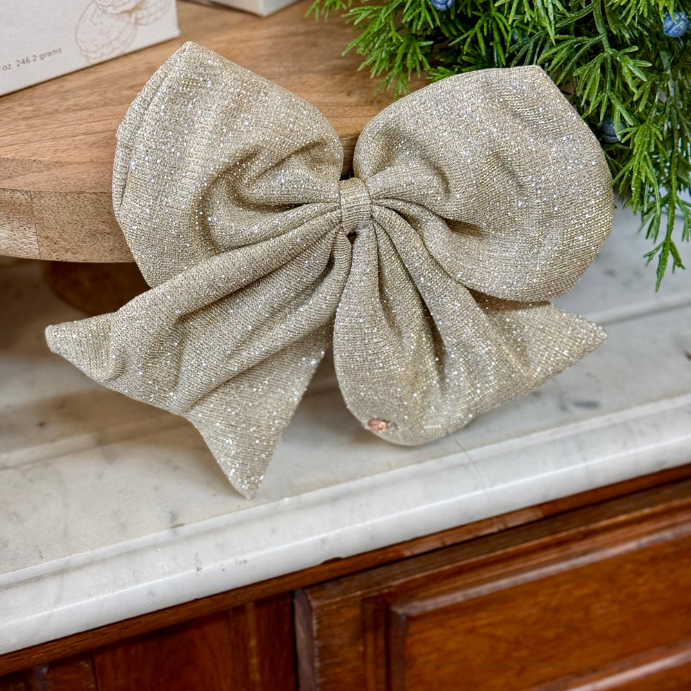 Shimmering gold fabric holiday magnetic bows.