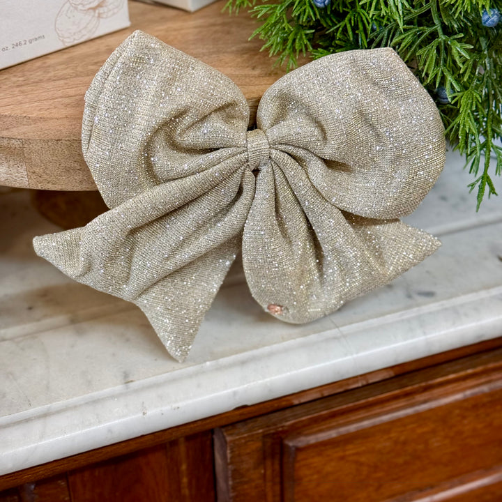 Shimmering gold fabric holiday magnetic bows.