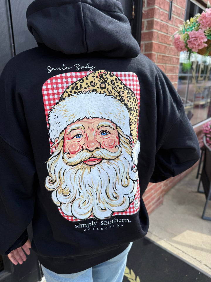 Black Merry Vibes Santa Hoodie with back graphic of Santa Claus in a leopard-print hat on a red and white checkered background, “Santa Baby” text, and brand details. Available in all sizes.