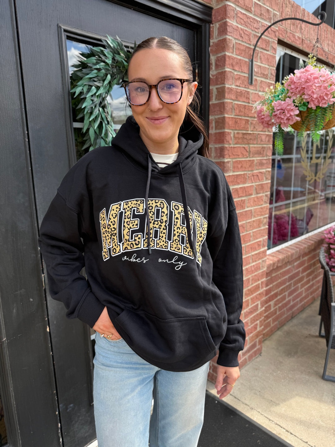 Black Merry Vibes Santa Hoodie with leopard print “MERRY” and “vibes only” script. Available in all sizes.