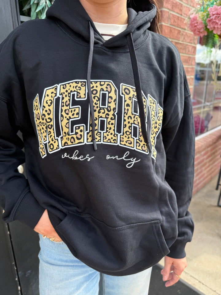 Black Merry Vibes Santa Hoodie with leopard print “MERRY” and white cursive “vibes only” text. Available in all sizes.