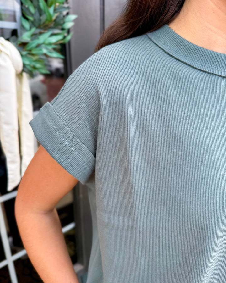 Blue-grey ribbed short-sleeve top with crew neck and cuffed sleeves from the Scout Ribbed Set. Available in sizes XS-XL.