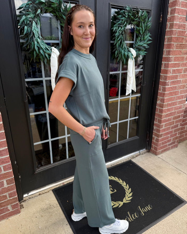 Scout Ribbed Set in sage green with a short-sleeved top and wide-leg drawstring pants with pockets.