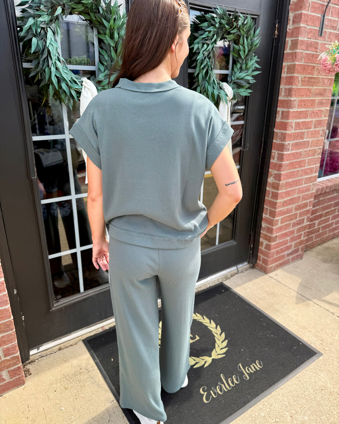 Sage green Scout Ribbed Set with a short-sleeved collared top and wide-leg pants. Available in sizes XS-XL.