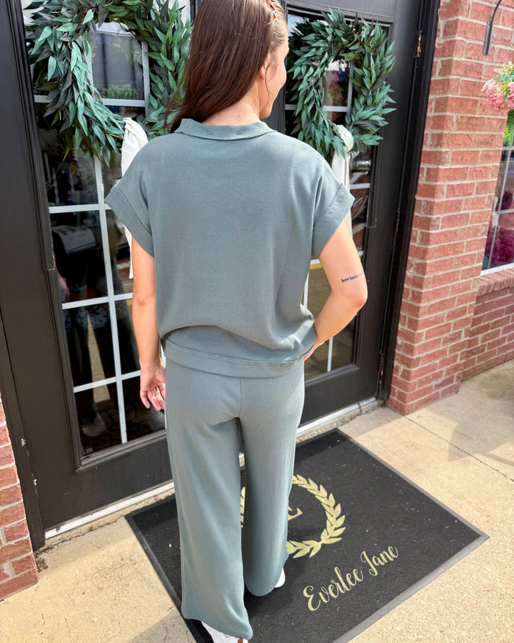 Sage green Scout Ribbed Set with a short-sleeved collared top and wide-leg pants. Available in sizes XS-XL.