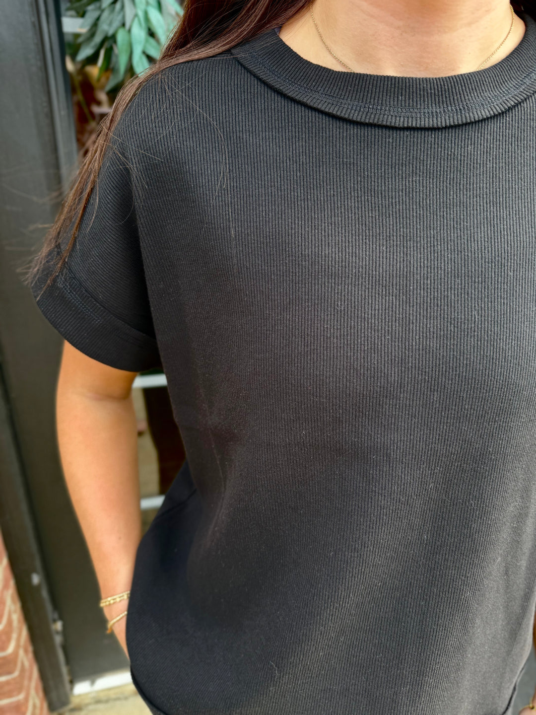 Black short-sleeved Scout Ribbed Set top, ribbed texture, round neckline. Available in various sizes.