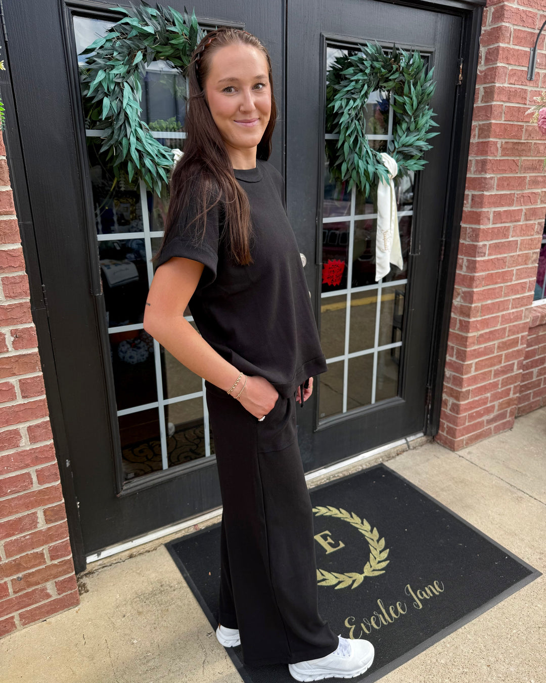 Scout Ribbed Set: black short-sleeved top and matching wide-leg pants. Available in sizes [insert sizes].