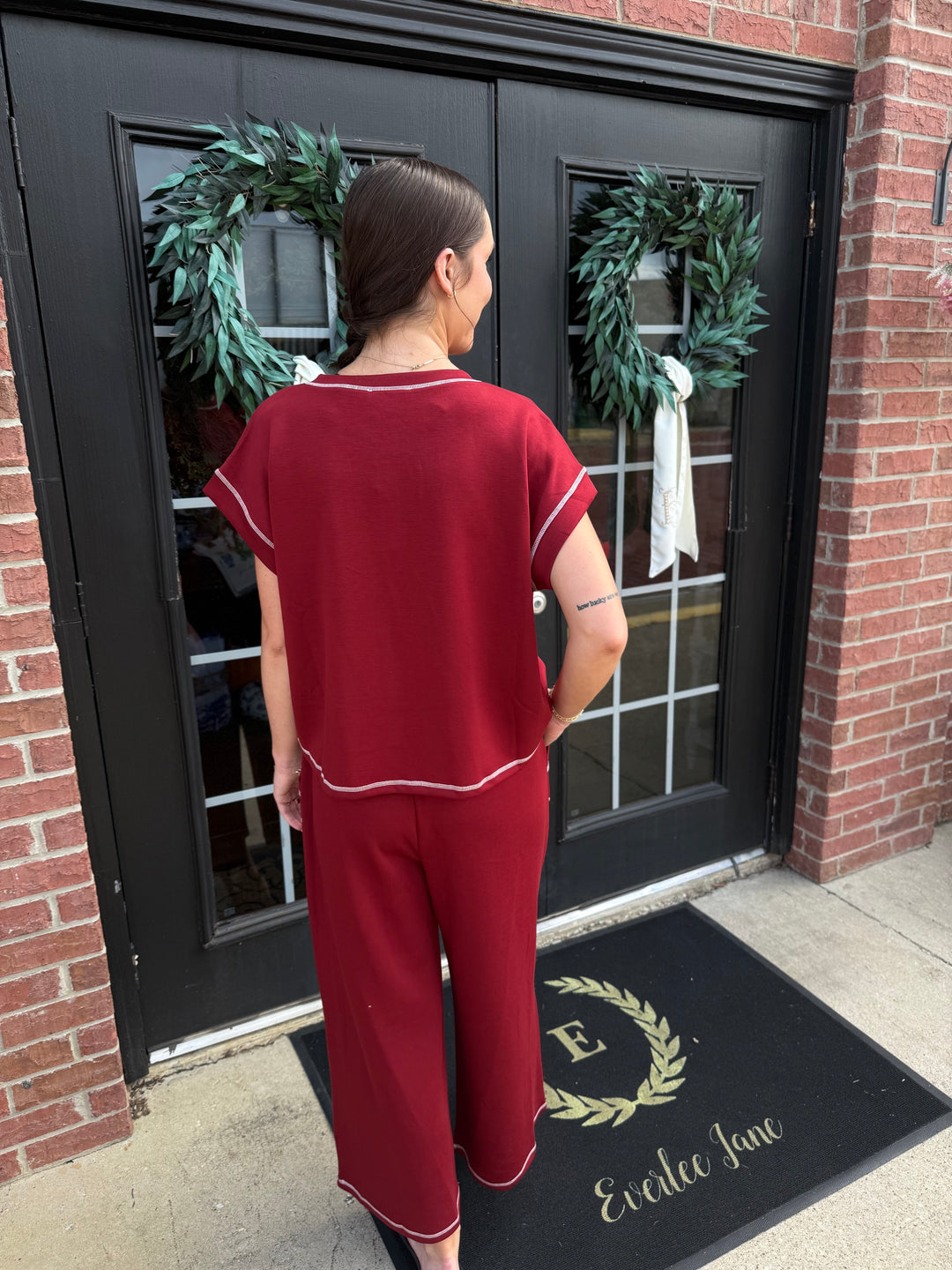 Maroon short-sleeved scuba lounge set with wide-leg pants and white contrast stitching. Available in multiple sizes.