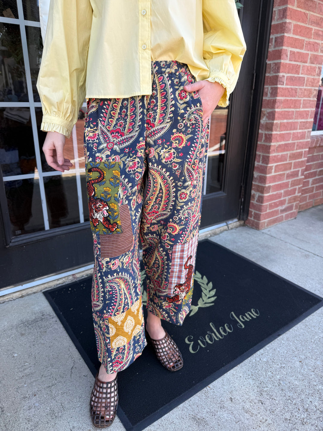 Tiger Barrel Pant in dark blue, red, and yellow paisley print with a wide-leg, barrel shape, elastic waistband, and side pockets.