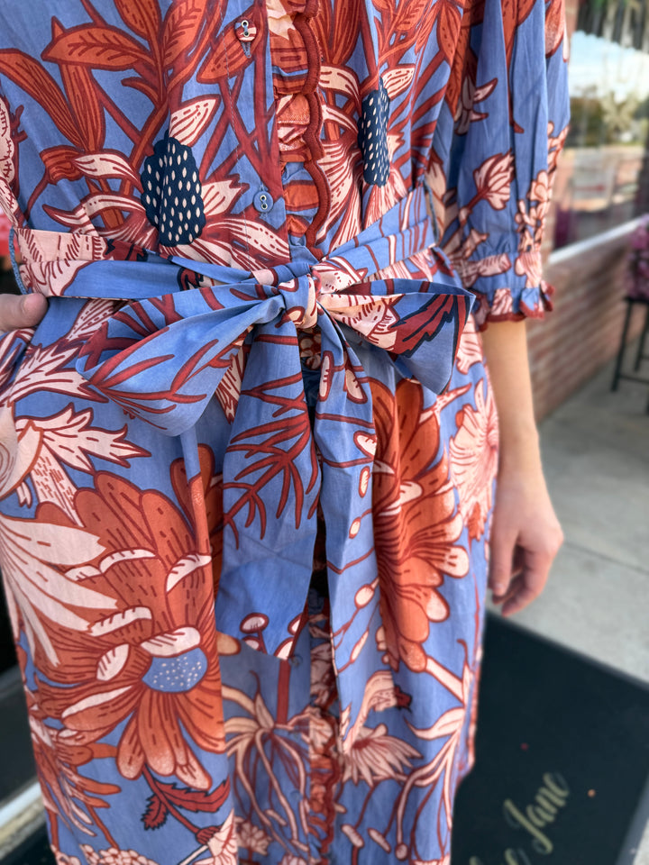 Blue and orange floral midi dress with button-down bodice, waist tie, and scallop trim. Available in multiple sizes.
