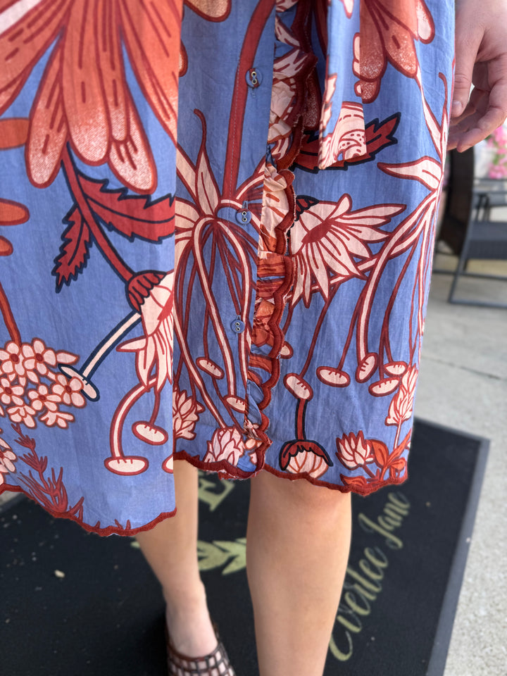Blue floral button-front midi dress with embroidered scallop trim. Available in multiple sizes.