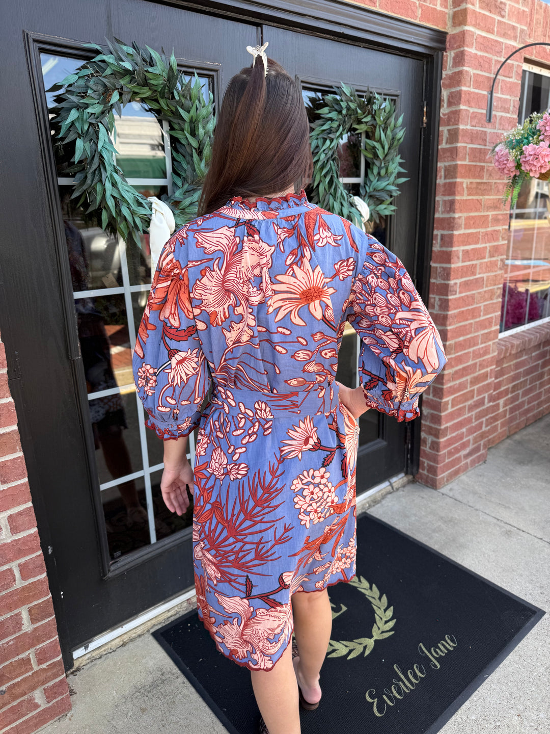 Blue and orange floral midi dress with ruffled neckline and embroidered scallop trim hem. Available in multiple sizes.