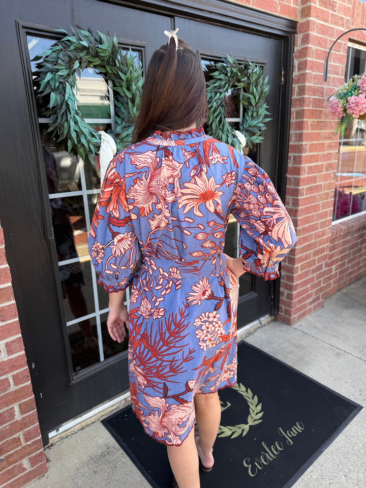 Blue and orange floral midi dress with ruffled neckline and embroidered scallop trim hem. Available in multiple sizes.