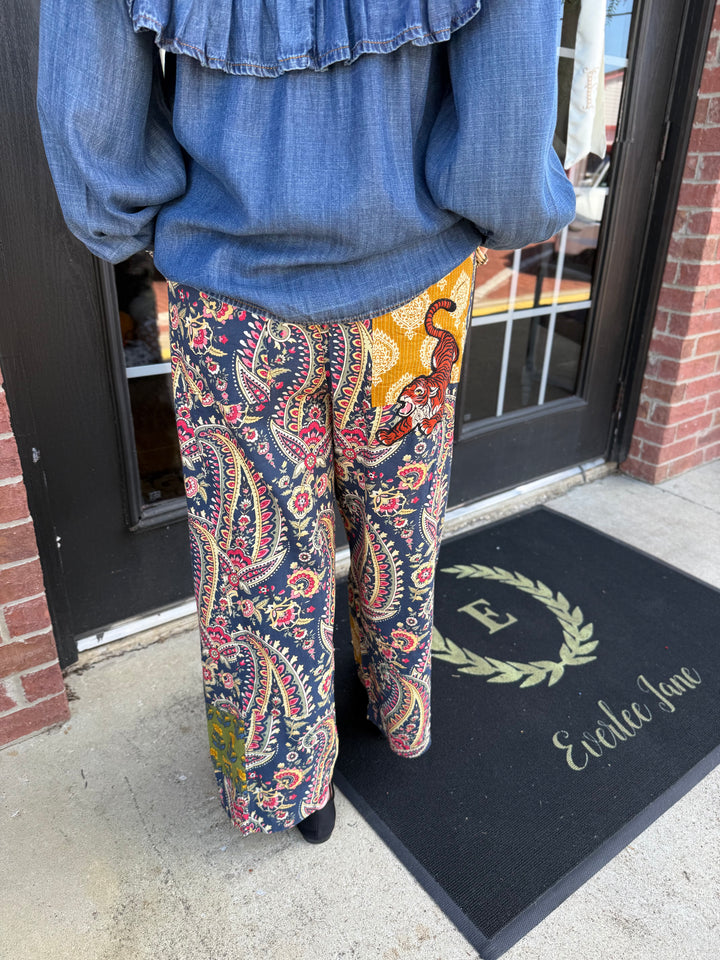 Tiger Barrel Pant in dark navy paisley, wide-leg, barrel-leg silhouette with mustard-yellow panel and tiger graphic. Available in all sizes.