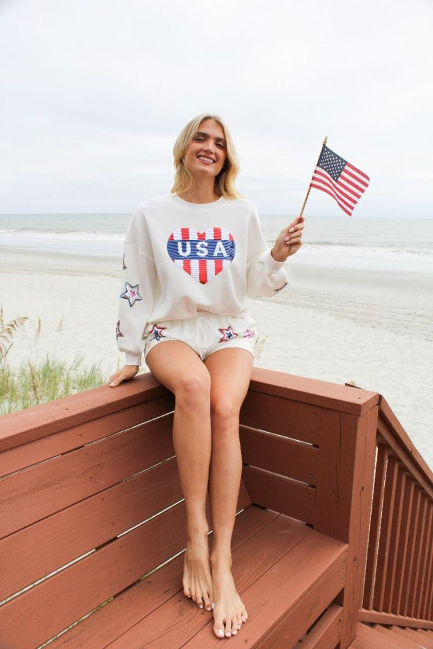 White sweater with USA in a heart image. Front view of top. 