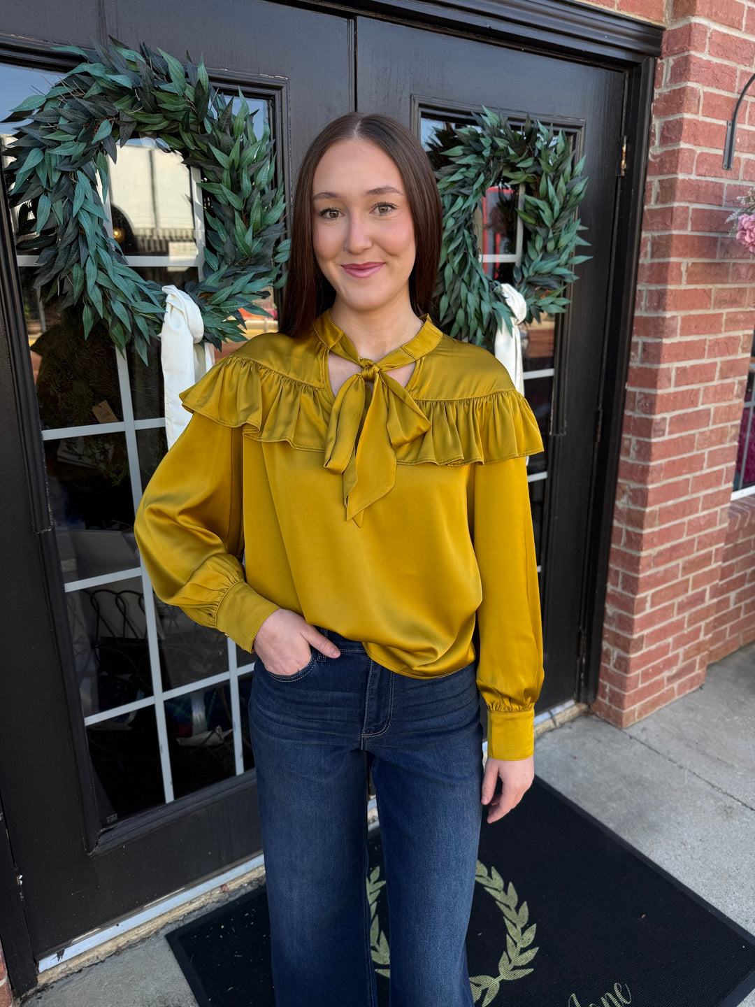 Chartreuse silky long-sleeve blouse with a ruffled yoke and a bow neck tie.