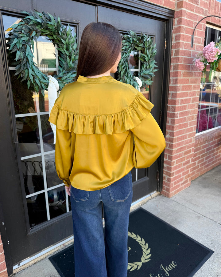 Chartreuse silky bow neck top with long sleeves, ruffled yoke, and high neck. Available in various sizes.