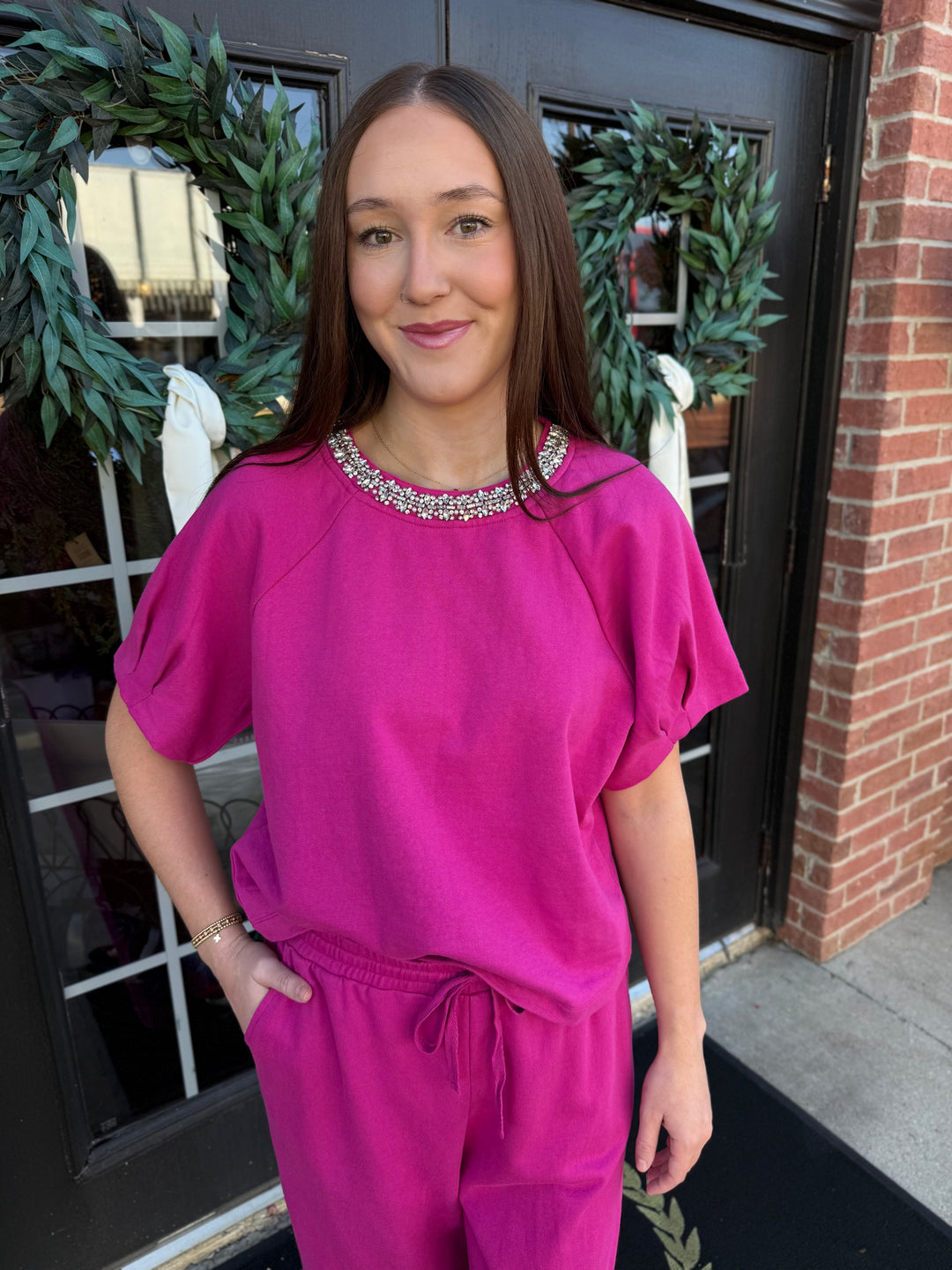 Fuchsia short-sleeve sparkle neck top with rhinestone-embellished round collar.