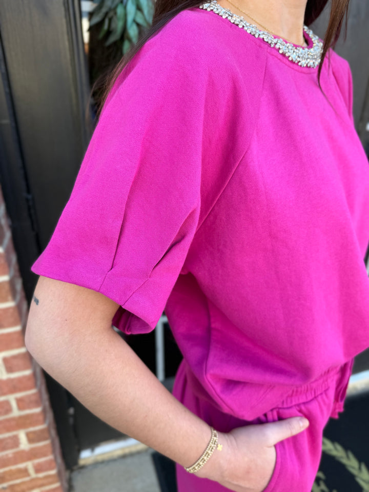 Fuchsia Sparkle Neck top, fuchsia short-sleeve cotton top with jewel-encrusted neckline. Sizes available.