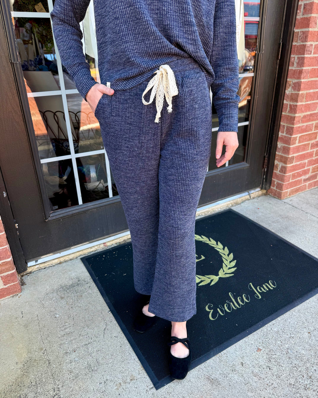 Dusk Knit Cord Pant in dark blue. Ribbed knit, wide straight-leg, side pockets, cream drawstring elastic waistband. Available in all sizes.