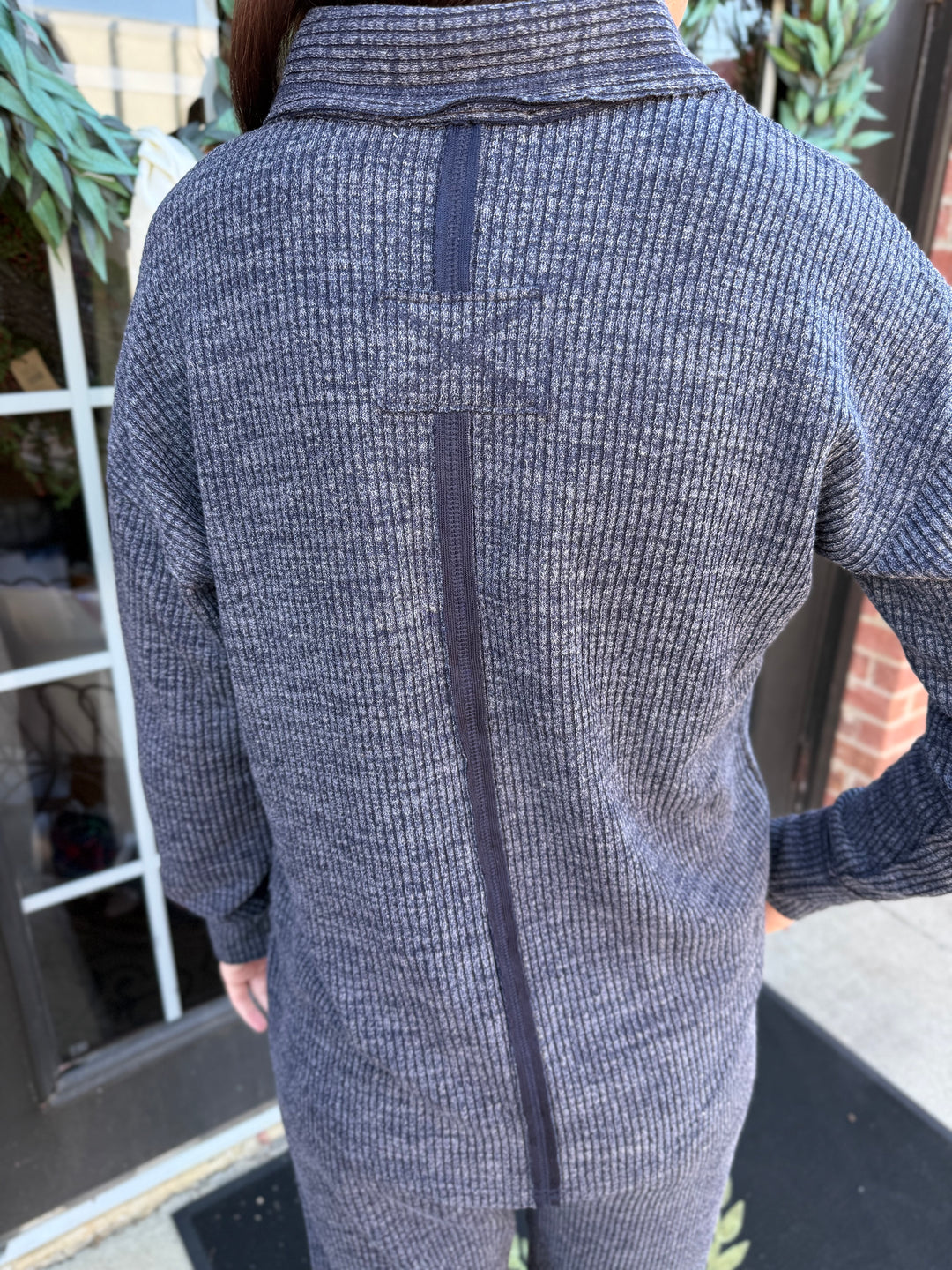 Dusk Knit Cord V-Neck sweater in dark grey, relaxed fit, vertical back seam, folded collar. Available in various sizes.