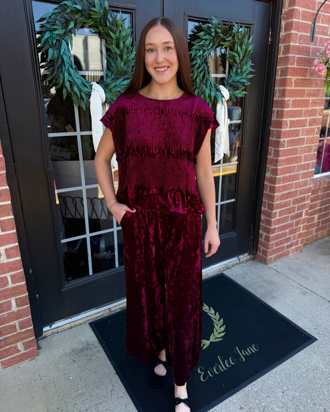 Cranberry velvet top and wide-leg pant set featuring a smocked bodice and wide smocked waistband. Available in all sizes.