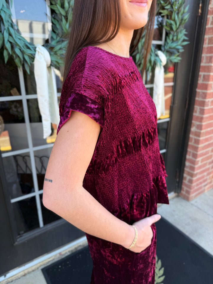 Cranberry velvet smocked peplum top, textured fabric, short sleeves. Available in all sizes.