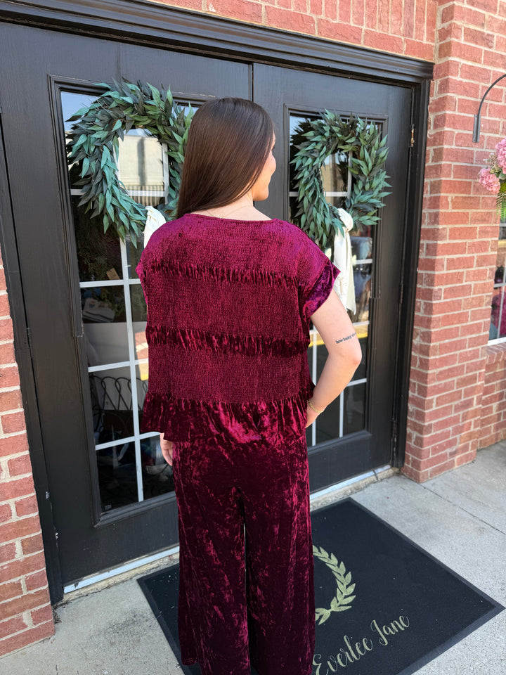 Cranberry velvet smocked peplum top.