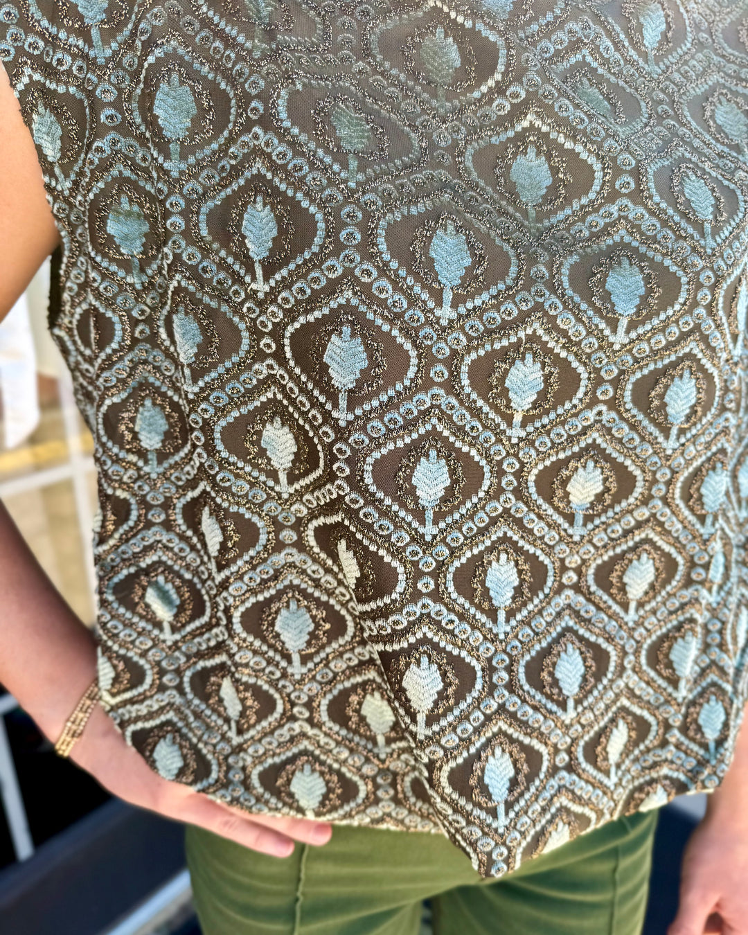 Sleeveless sage velvet mock neck top with metallic gold geometric diamond pattern and bubble silhouette.