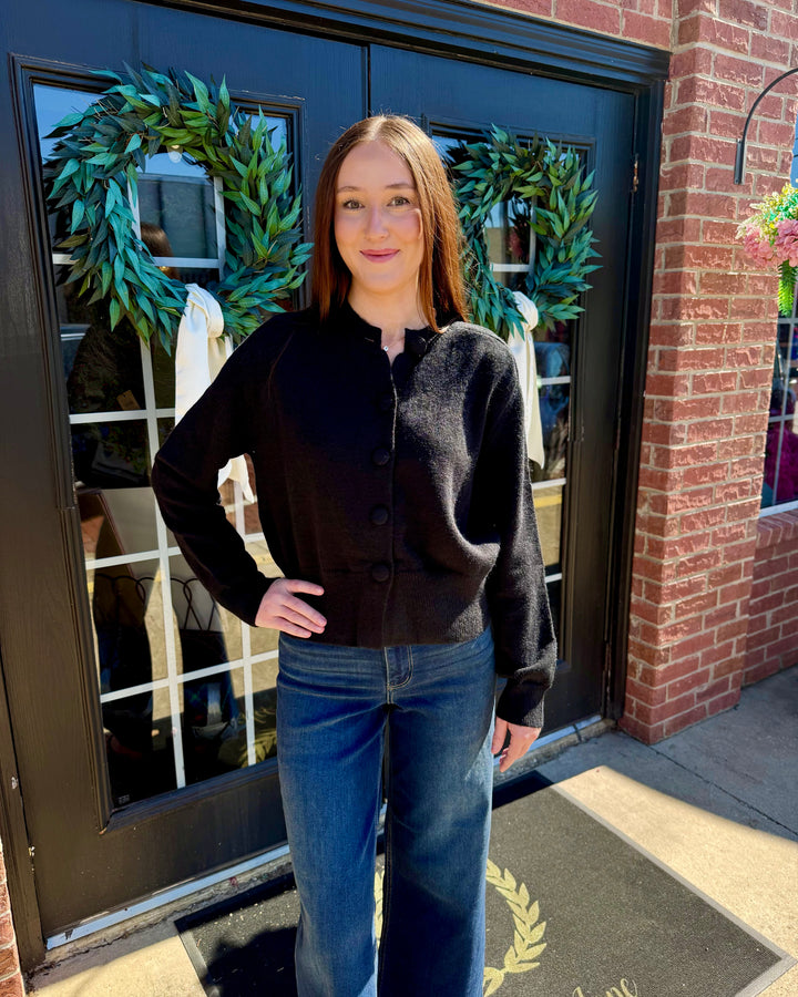 Black button-up cardigan, crew neckline, long sleeves. Available in all sizes.