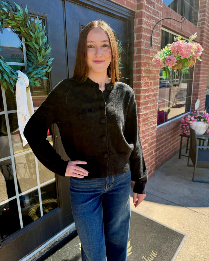 Black button-up long-sleeve cardigan.