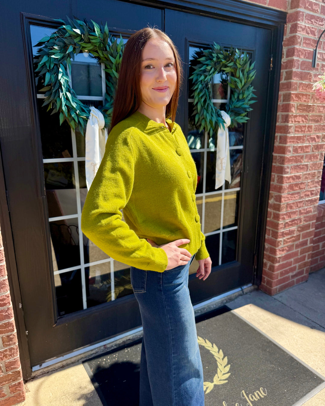 Olive green crew neck button-up cardigan with long sleeves. Available in all sizes.