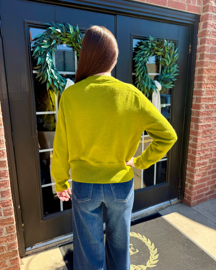 Lime green button-up cardigan with long sleeves and ribbed hem. Available in multiple sizes.