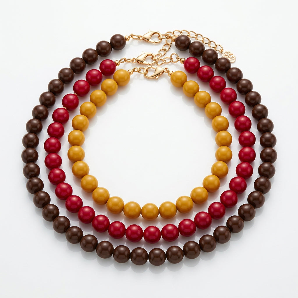 Sunset Beaded Necklace with three layered strands of brown, yellow, and magenta beads. Available in all sizes.