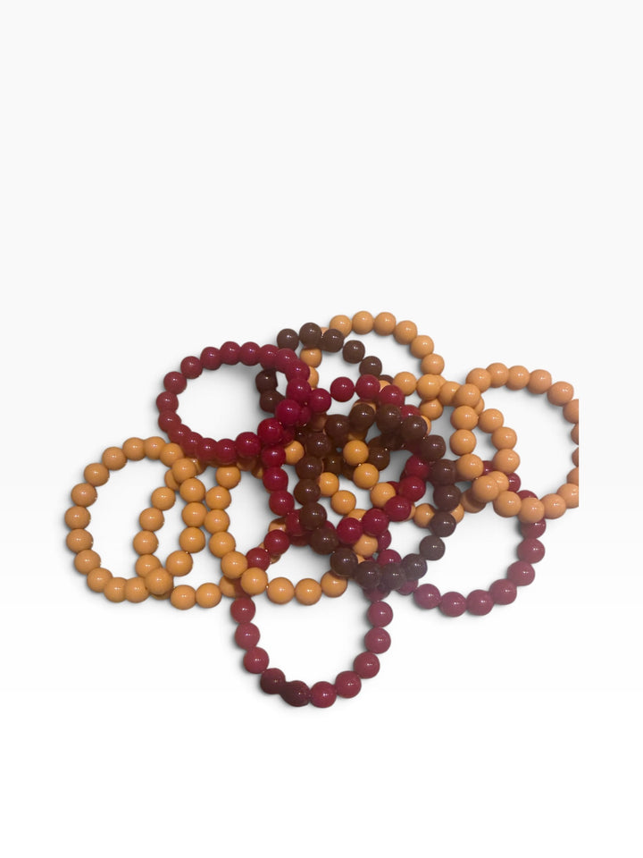 Beaded stretch bracelets in shades of tan, brown, and dark red.
