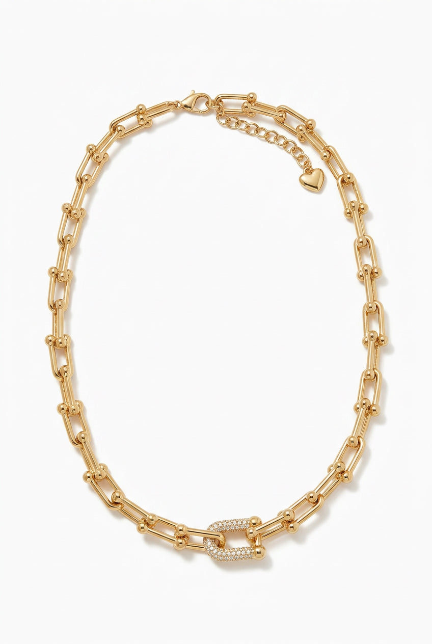 14K gold plated chainlink necklace with CZ, featuring a horseshoe link paved with cubic zirconia and a heart-shaped charm clasp.