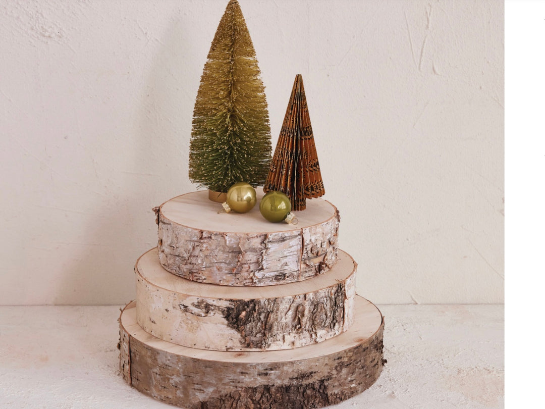 Three natural wood slices in graduated sizes stacked for a rustic, tiered display. Available in small, medium, and large.