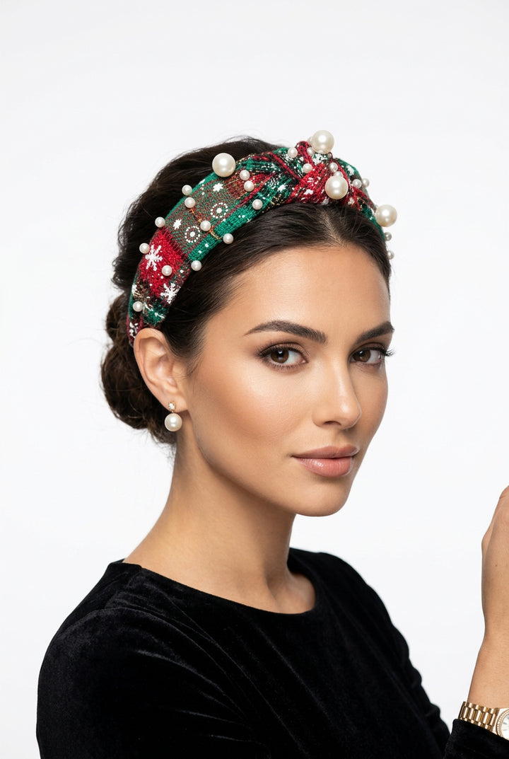 Festive red and green plaid knot headband with white embroidered snowflakes and faux pearls. One size.