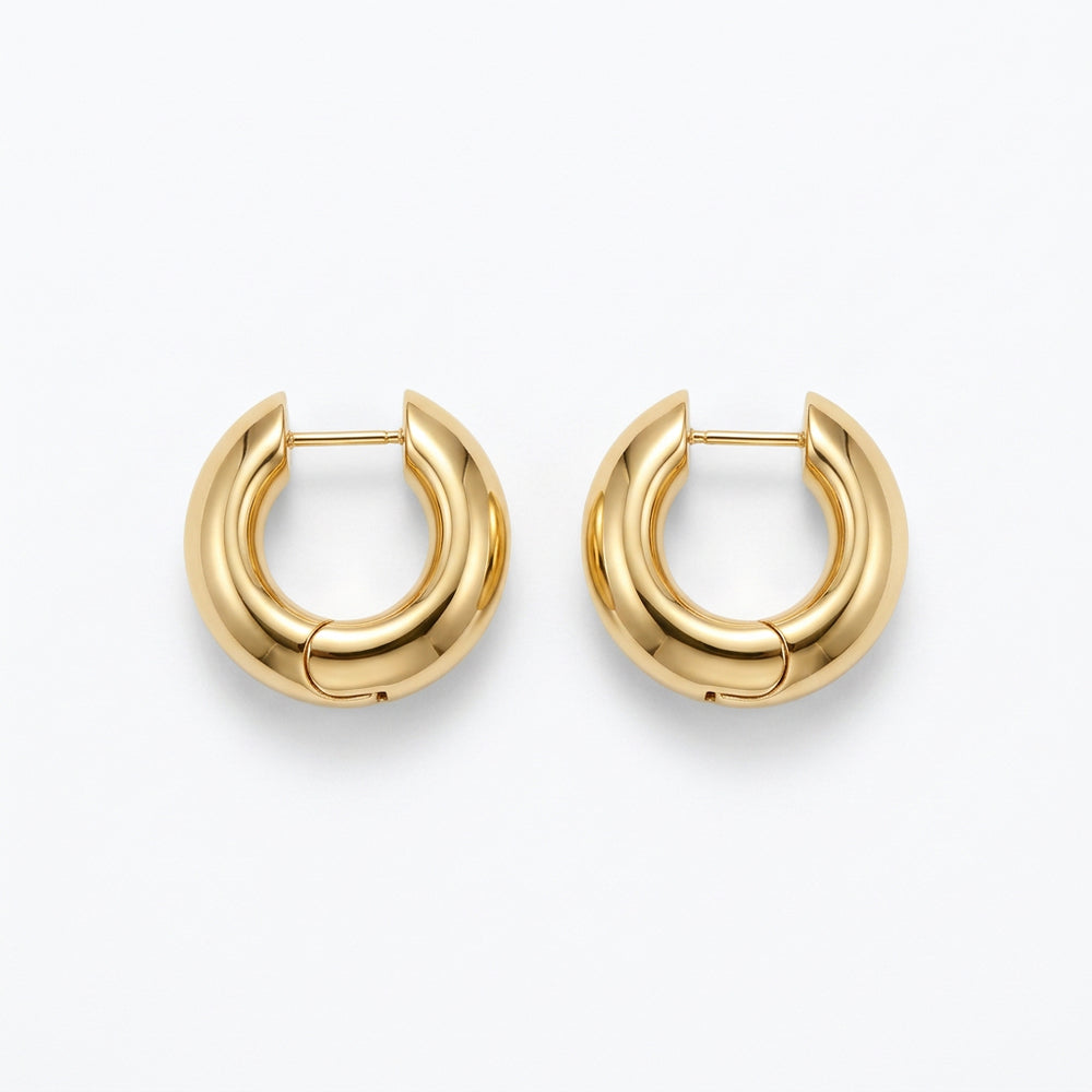 Kendra Scott Tatum Necklace and Hoop Earrings Box Set with thick, rounded gold hoop earrings.