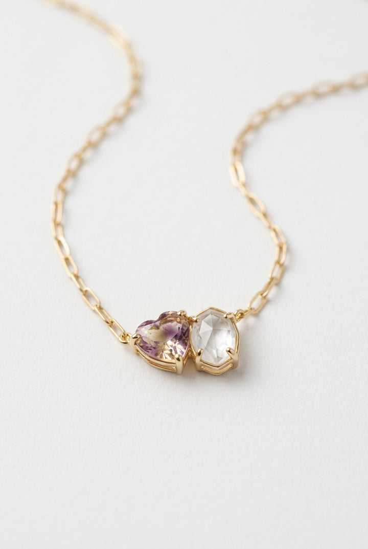 Kendra Scott Tatum Necklace and Hoop Earrings Box Set: gold chain necklace with heart-shaped purple stone and hexagonal clear stone pendants.