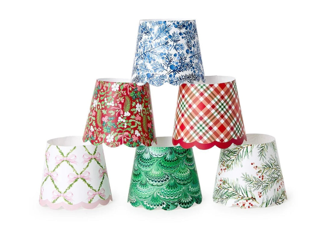Six scalloped-edge Holiday Paper Shade Covers in festive patterns.