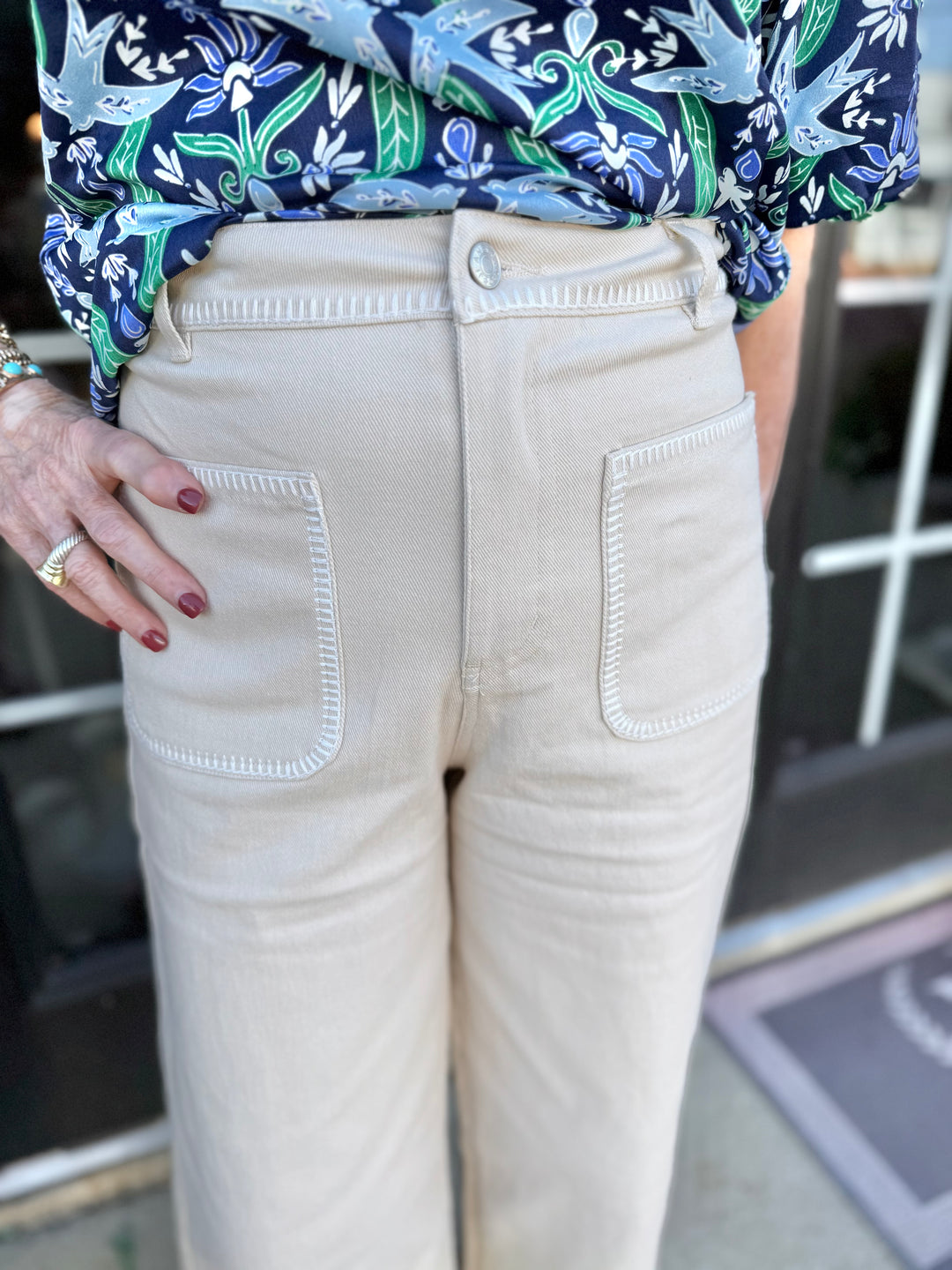 Ecru cream wide leg jeans with large front pockets, white stitching. Available in sizes XS-XL.