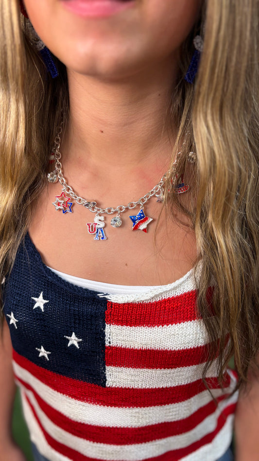 Knit top with American flag design, available in sizes XS-XL. No background or model visible.